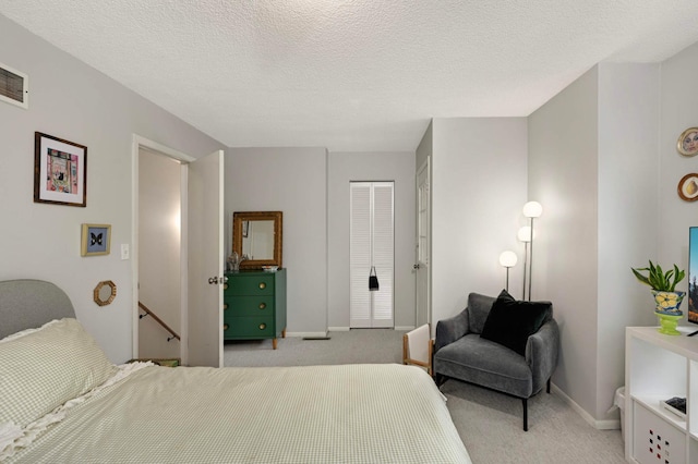3214 Blaisdell Ave, Minneapolis, MN 55408 - bedroom featuring light carpet, baseboards, a closet, and a textured ceiling