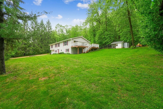W10005 710th Ave, River Falls, WI 54022 - view of green lawn featuring a wooden deck, a forest view, and stairway