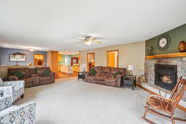 W10005 710th Ave, River Falls, WI 54022 - living room with light colored carpet, a fireplace, and ceiling fan