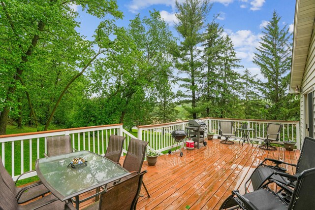 W10005 710th Ave, River Falls, WI 54022 - wooden terrace with outdoor dining area and a yard