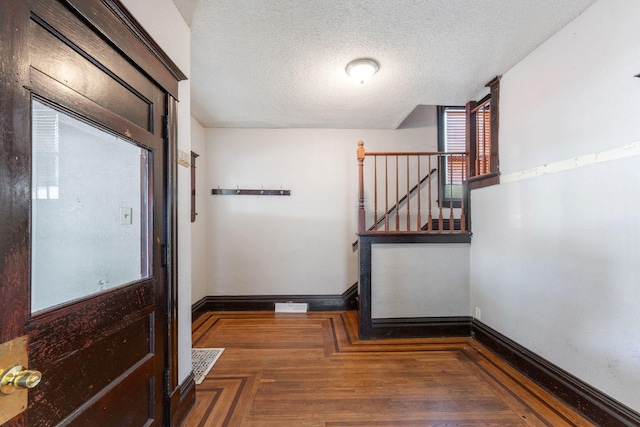 3413 Columbus Ave, Minneapolis, MN 55407 - doorway to outside with a textured ceiling, baseboards, wood finished floors, and stairs