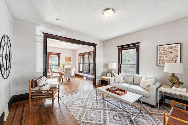 3413 Columbus Ave, Minneapolis, MN 55407 - living room with wood-type flooring, healthy amount of natural light, baseboards, and a textured ceiling