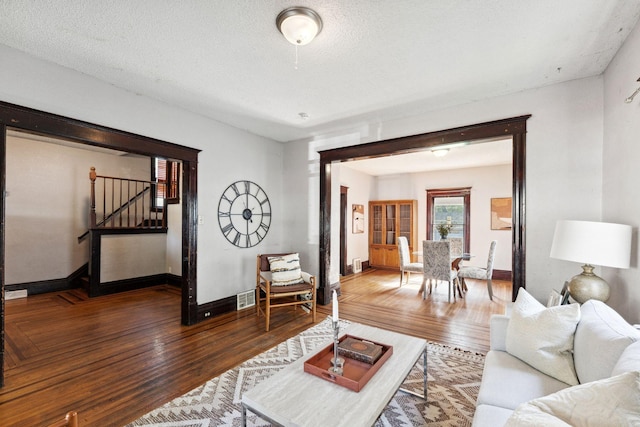 3413 Columbus Ave, Minneapolis, MN 55407 - living area with wood finished floors, baseboards, stairs, and a textured ceiling