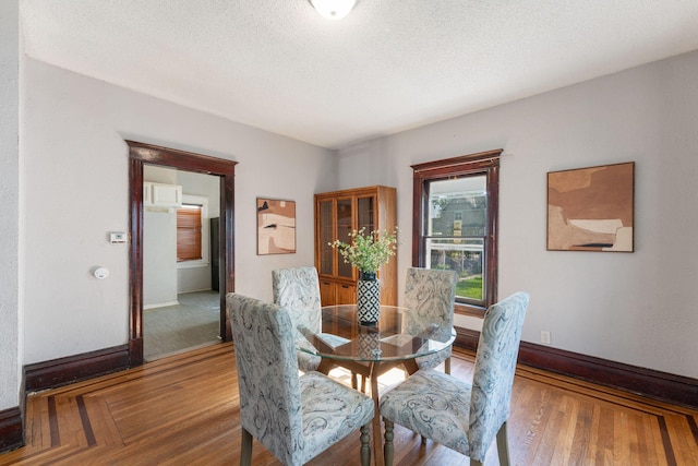 3413 Columbus Ave, Minneapolis, MN 55407 - dining space featuring baseboards, wood finished floors, and a textured ceiling
