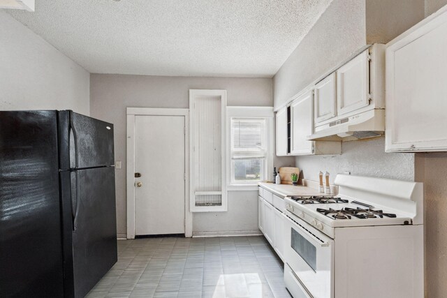 3413 Columbus Ave, Minneapolis, MN 55407 - kitchen with freestanding refrigerator, white gas range, under cabinet range hood, white cabinetry, and light countertops