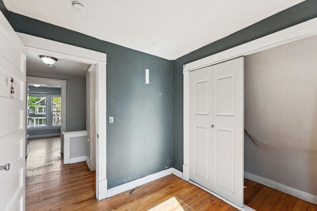 3413 Columbus Ave, Minneapolis, MN 55407 - unfurnished bedroom featuring wood-type flooring, baseboards, and a closet