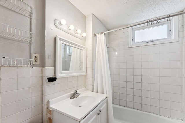 3413 Columbus Ave, Minneapolis, MN 55407 - full bathroom with shower / bath combo, vanity, a textured ceiling, and tile walls