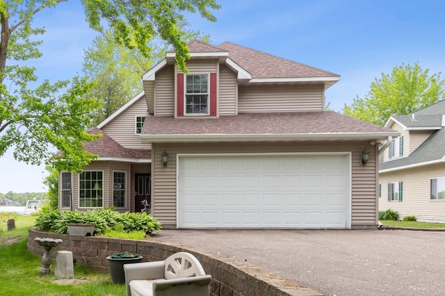 27180 Lakewood Dr NW, Stanford Twp, MN 55040 - traditional-style house featuring a shingled roof, a garage, and asphalt driveway