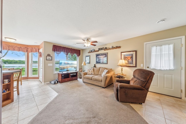 27180 Lakewood Dr NW, Stanford Twp, MN 55040 - living area featuring light tile patterned floors, ceiling fan, and a textured ceiling