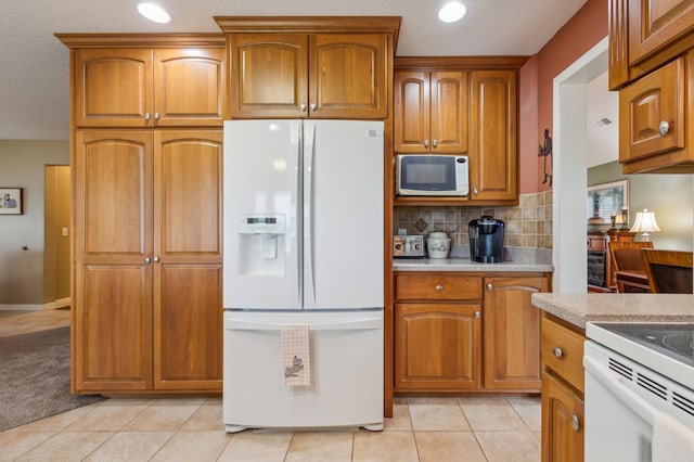 27180 Lakewood Dr NW, Stanford Twp, MN 55040 - kitchen featuring white appliances, brown cabinetry, and light countertops