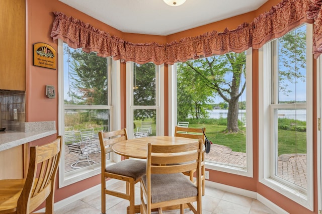 27180 Lakewood Dr NW, Stanford Twp, MN 55040 - dining room with a water view, healthy amount of natural light, and light tile patterned flooring