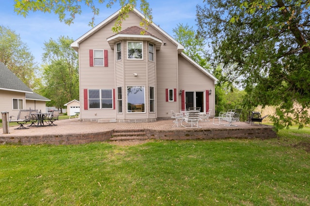 27180 Lakewood Dr NW, Stanford Twp, MN 55040 - rear view of property featuring a patio and a yard