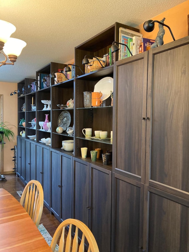 875 20th St, Windom, MN 56101 - dining space with a textured ceiling, dark wood finished floors, and a chandelier