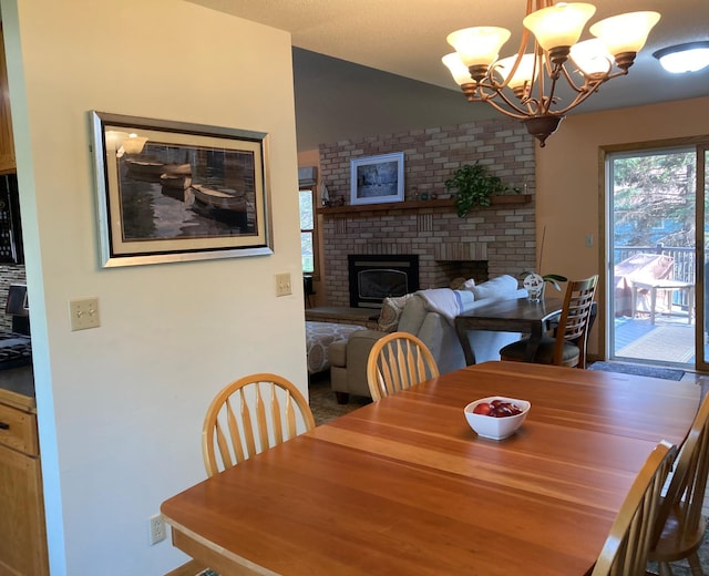 875 20th St, Windom, MN 56101 - dining room featuring a brick fireplace, a chandelier, and vaulted ceiling
