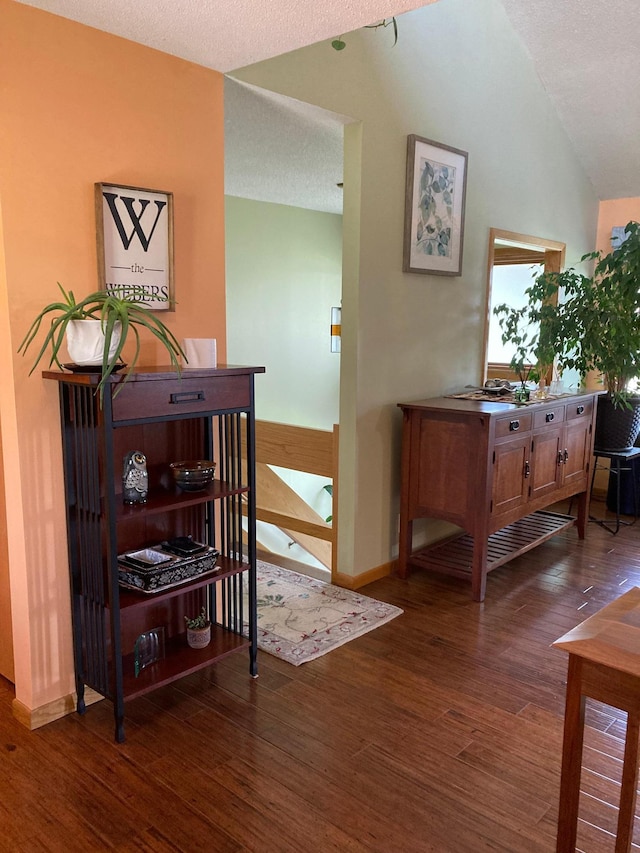 875 20th St, Windom, MN 56101 - hallway featuring wood finished floors, a textured ceiling, vaulted ceiling, and baseboards
