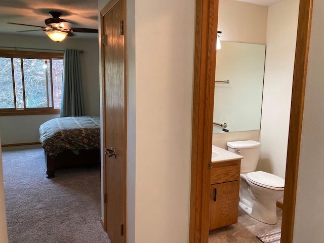 875 20th St, Windom, MN 56101 - bathroom featuring a ceiling fan, toilet, vanity, ensuite bathroom, and baseboards