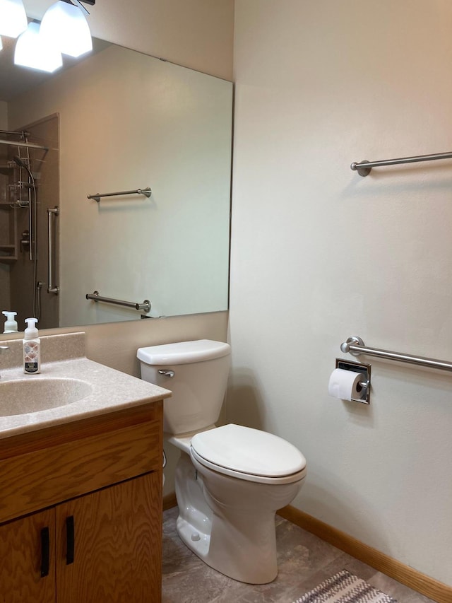 875 20th St, Windom, MN 56101 - bathroom featuring toilet, a shower, vanity, and baseboards