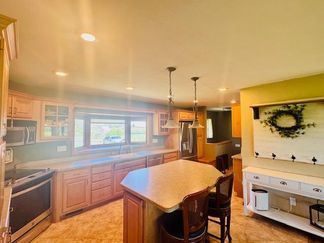 1539 111th St, Slayton Twp, MN 56172 - kitchen featuring stainless steel appliances, a sink, a kitchen island, light countertops, and recessed lighting