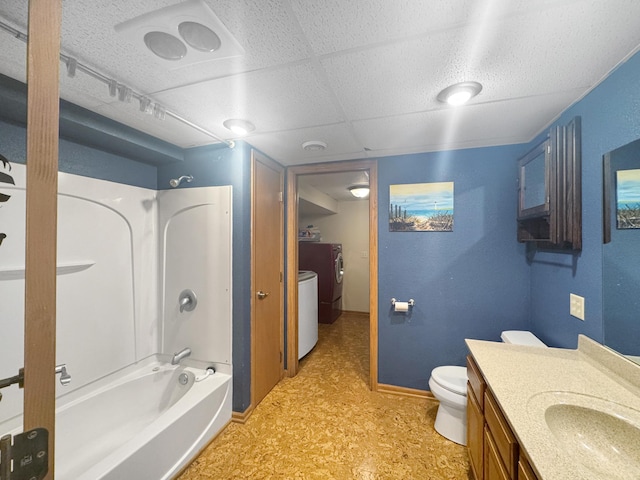 1539 111th St, Slayton Twp, MN 56172 - bathroom with vanity, toilet, washing machine and clothes dryer, tub / shower combination, and tile patterned floors