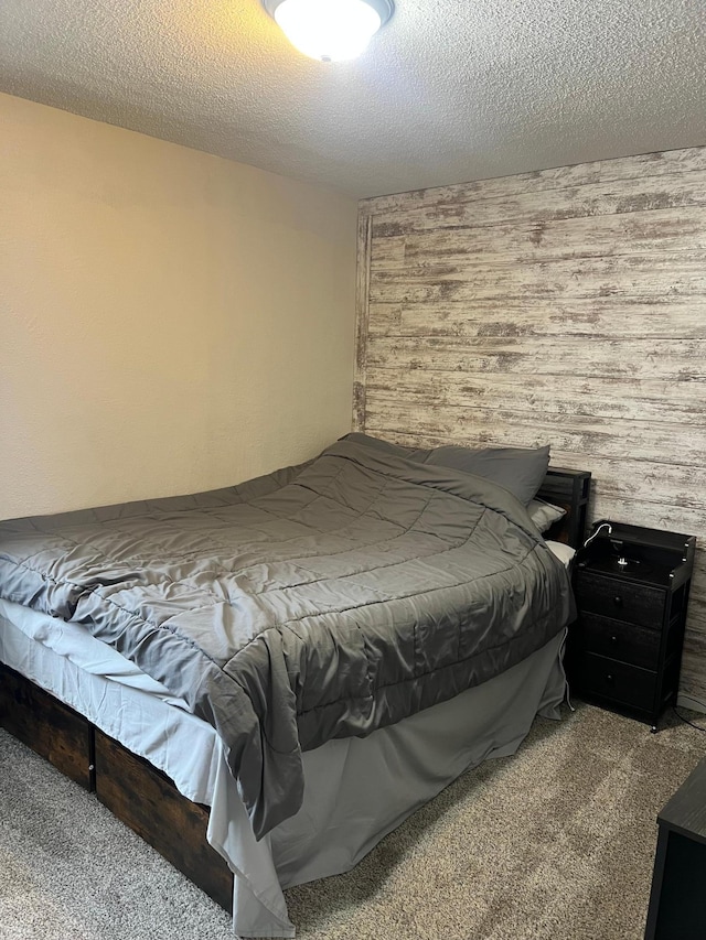 carpeted bedroom featuring a textured ceiling