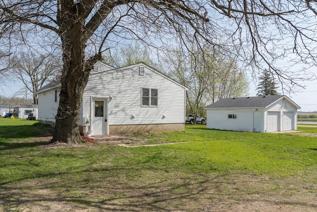 5433 511th Street Way, Kenyon Twp, MN 55946 - back of house with a garage, a lawn, and an outdoor structure