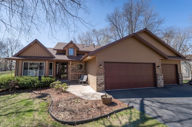craftsman-style house featuring a garage, driveway, brick siding, and a shingled roof