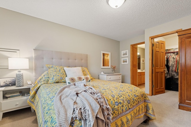 carpeted bedroom with a spacious closet, a closet, and a textured ceiling