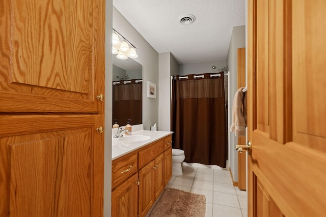 bathroom with toilet, tile patterned floors, vanity, a textured ceiling, and a shower with curtain