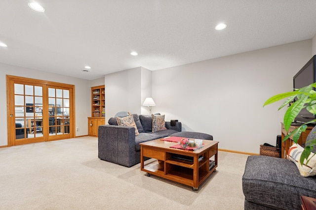living room with recessed lighting, light colored carpet, and baseboards