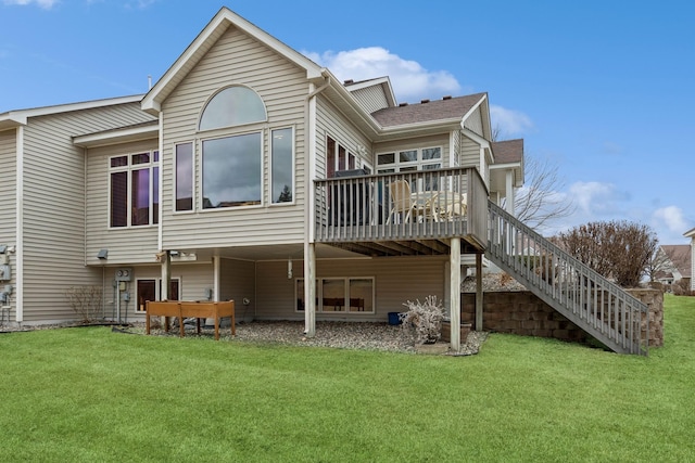 back of property featuring a lawn, a deck, and stairway