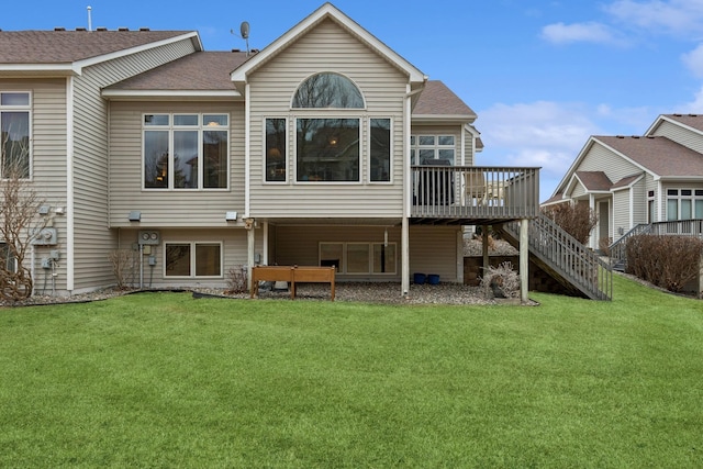 back of house featuring a deck, a yard, stairs, and a shingled roof