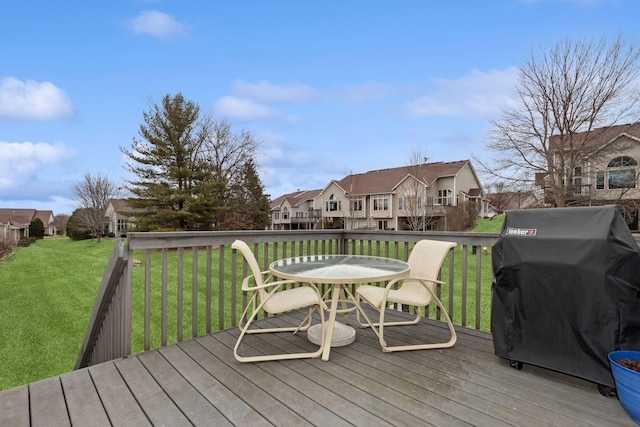 wooden terrace featuring a residential view, grilling area, and a lawn