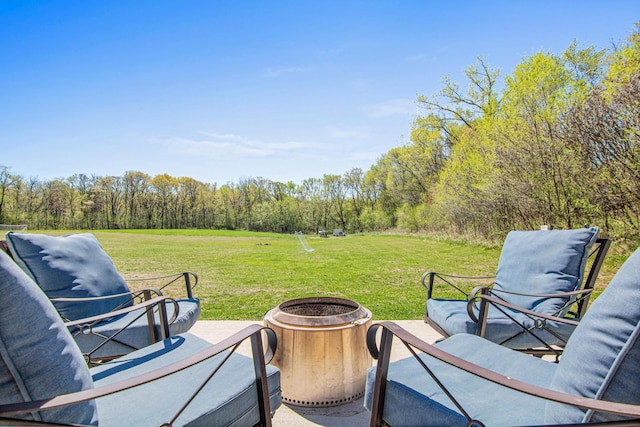 968 150th Ave, New Richmond, WI 54017 - view of grassy yard with an outdoor fire pit and a forest view