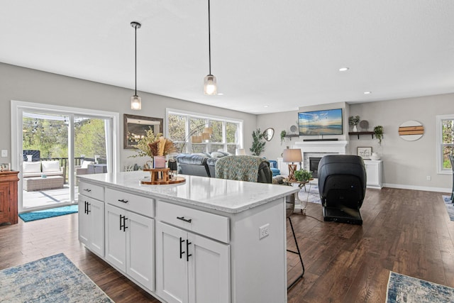 968 150th Ave, New Richmond, WI 54017 - kitchen with a kitchen island, dark wood-style floors, recessed lighting, white cabinets, and a fireplace