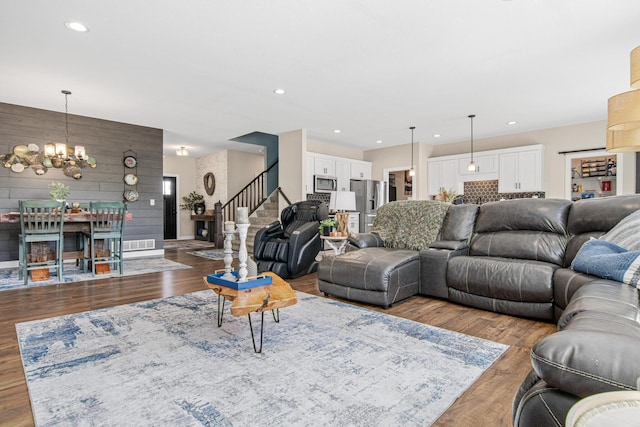 968 150th Ave, New Richmond, WI 54017 - living room with stairway, a chandelier, wood finished floors, recessed lighting, and wood walls