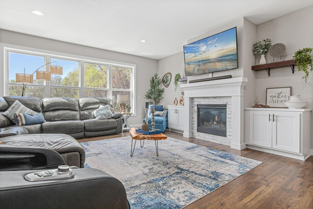 968 150th Ave, New Richmond, WI 54017 - living room featuring wood finished floors, a glass covered fireplace, recessed lighting, and baseboards