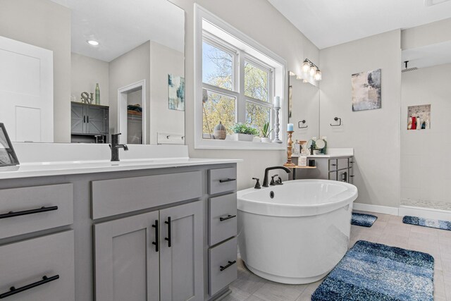968 150th Ave, New Richmond, WI 54017 - full bathroom with a tile shower, a freestanding tub, vanity, baseboards, and tile patterned floors