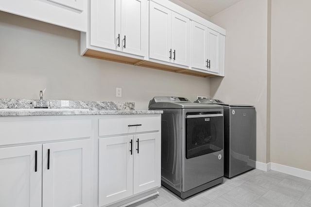 968 150th Ave, New Richmond, WI 54017 - laundry area with cabinet space, washer and dryer, baseboards, and light floors