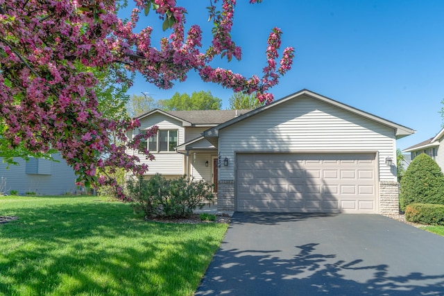 1434 Benson Blvd E, Stillwater, MN 55082 - split level home with a garage, driveway, a front lawn, and brick siding