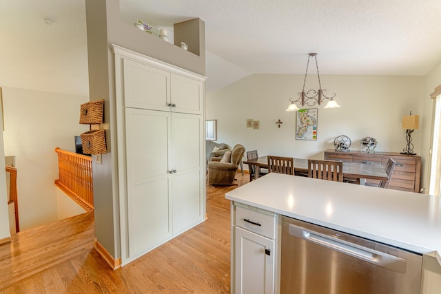 1434 Benson Blvd E, Stillwater, MN 55082 - kitchen featuring stainless steel dishwasher, light wood-style floors, white cabinets, hanging light fixtures, and lofted ceiling