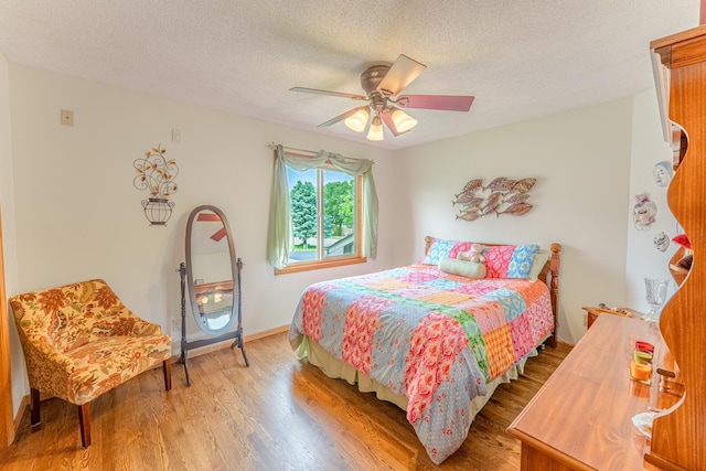 1434 Benson Blvd E, Stillwater, MN 55082 - bedroom featuring wood finished floors, a textured ceiling, and ceiling fan