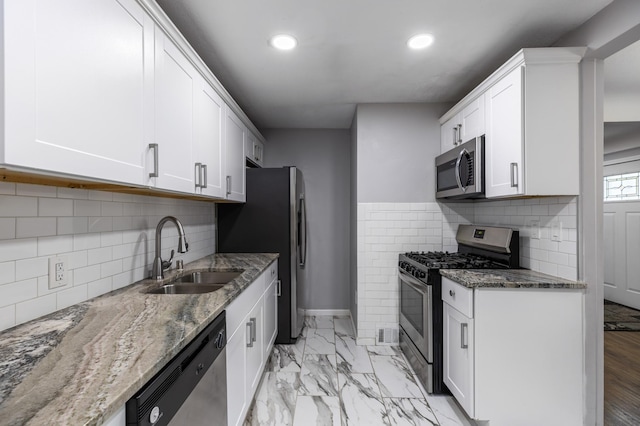 5548 34th Ave S, Minneapolis, MN 55417 - kitchen featuring stainless steel appliances, a sink, recessed lighting, stone countertops, and white cabinets