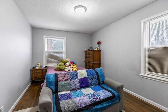 5548 34th Ave S, Minneapolis, MN 55417 - bedroom with wood finished floors, a textured ceiling, and baseboards