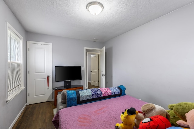 5548 34th Ave S, Minneapolis, MN 55417 - bedroom featuring a textured ceiling, baseboards, and wood finished floors
