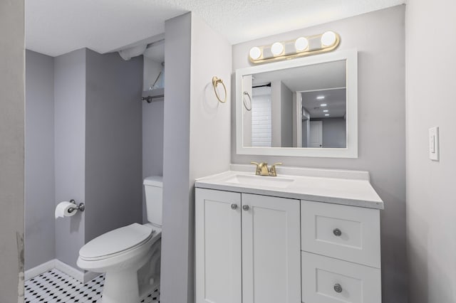5548 34th Ave S, Minneapolis, MN 55417 - bathroom featuring toilet, vanity, baseboards, and a textured ceiling