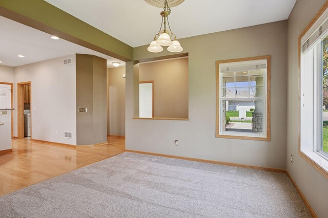 unfurnished room featuring carpet flooring, healthy amount of natural light, washer / dryer, and recessed lighting