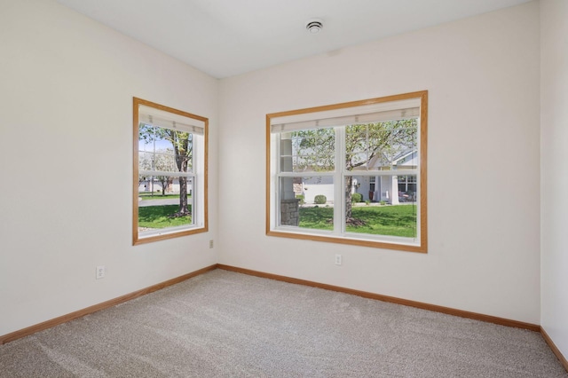 empty room with carpet flooring and baseboards