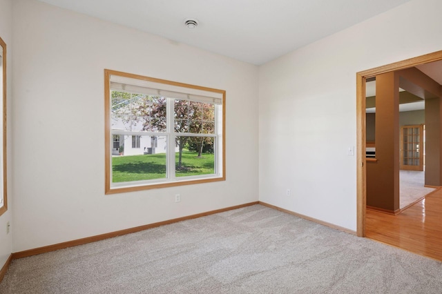 carpeted empty room with baseboards