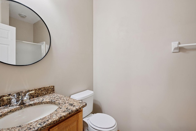 bathroom with toilet and vanity