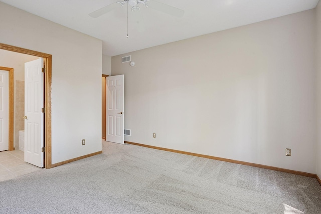 empty room with light carpet, a ceiling fan, and baseboards